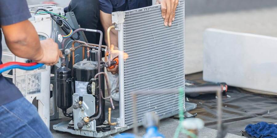 Technicians working on AC